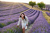 Young girl 30-35 years old, Cultivation of Lavender, Lavender in bloom, Valensole, Alpes-de-Haute-Provence, Provence-Alpes-Côte d'Azur, France, Europe