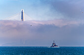  Coast Guard boat on the Bosphorus in front of the Yavuz Sultan Selim Bridge in the fog near Istanbul, Türkiye  