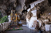  Hundreds of miniature Buddha sculptures adorn the lower cave in the Pak Ou Caves, Pak Ou, Pak Ou District, Luang Prabang, Laos, Asia 