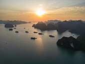  Aerial view of cruise ships and tour boats with karst islands at sunrise, Lan Ha Bay, Haiphong, Vietnam, Asia 