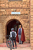 Bike rider in front of the "Auberge-restaurant" in the village of Telouet, Ouarzazate Province, region of Draa-Tafilalet, Morocco, North West Africa