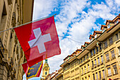 Beautiful Old City Street with Old Building and Flags in a Sunny Summer Day in City of Bern, Canton Bern, Switzerland.