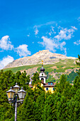 Church Tower and Street Lamp in the Forest and Mountain in a Sunny Summer Day in Engandine, Maloja, Celerina, Schlarigna, Grisons, Switzerland,