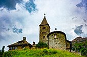Beautiful Church with Bell Tower in Old Town in a Summer Day with Storm Clouds in Samedan, Grisons, Switzerland.