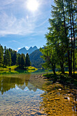 Beautiful Alpine Lake Preda, Lai da Palpuogna in a Mountain Valley in the Swiss Alps in a Sunny Summer Day with Blue Sky and Clouds in Albula, Bergün, Filisur, Grisons, Switzerland.