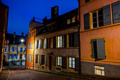 Cobblestone Street in Old Town with Illuminated House and Window in Dusk in City of Neuchatel, Canton Neuchatel, Switzerland.
