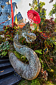 Intricately carved stone dragon statue in the garden at Blanco Renaissance Museum. Ubud, Bali, Indonesia.