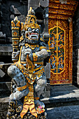 Intricately carved stone statue of a guardian at Batu Mejan Temple (Pura Batu Mejan). Tanah Lot, Bali, Indonesia.