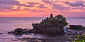 Panoramic view of the iconic Tanah Lot island temple at sunset. Bali, Indonesia.