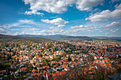  Wide view over a colorful small town landscape surrounded by rolling hills, Wernigerode, Saxony-Anhalt, Germany 