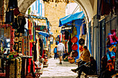  Covered souk with textiles, bags and handicrafts in the Medina in Hammamet, Tunisia 