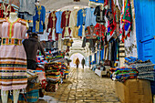  Souk with clothes and cloths (foutas) in the Medina in Nabeul, Tunisia 