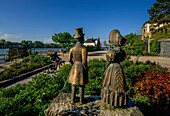  View from the front garden of the Electoral Castle with Biedermeier figures to the square of Montrichard and the Rhine, Eltville, Rheingau, Hesse, Germany 
