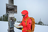  Woman hiking, signing summit book, Schönfeldjoch, Mangfall Mountains, Tyrol, Austria 