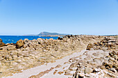  Weathered, pillow-like lava rocks and bizarre rock formations on the coast near El Haouria with a view of Cap Bon, Tunisia 