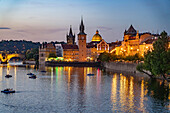 Vltava river bank with Old Town Water Tower, Novotný pier and Charles Bridge at dusk, Prague, Czech Republic 
