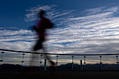  Long exposure of a marathon runner training on board an expedition cruise ship (Ocean Albatros, Albatros Expeditions) a few days before arriving on King George Island in Antarctica where the marathon will take place, in the Beagle Channel between Argentina and Chile, South America  