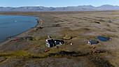  Aerial view of historic fur traders&#39; buildings and vast landscape, Myggbukta, Arctic Greenland, Europe 