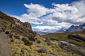  Woman hiking on the Aonikenk Trail during a trip in Torres del Paine National Park, Torres del Paine, Magallanes y de la Antartica Chilena, Patagonia, Chile, South America 