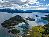  Aerial view of Zodiac inflatable boats transporting passengers of the expedition cruise ship Ventus Australis (Australis Cruises) for a hiking excursion in Wulaia Bay, Isla Navarino, Cape Horn, Magallanes and Chilean Antarctica, Patagonia, Chile, South America 