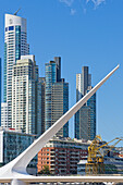  The Puente de la Mujer bridge and skyscrapers in the Puerto Madero harbor district, Buenos Aires, Argentina, South America 