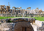  Theater with columns of the stage and tiers, ruins of ancient Thugga at the archaeological site near Dougga, Tunisia 