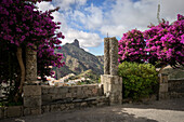  Purple flowering bush and stone bench in the historically beautiful town of Tejeda with the rock formation &quot;Roque Bentayga&quot;, Gran Canaria, Canary Islands, Spain, Europe 
