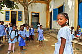 Pupils playing bungee jumping in the playground of the primary school in the village of Praia das Conchas, in the northern part of Sao Tome Island, Republic of Sao Tome and Principe,Africa