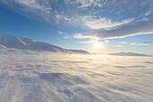 Midnight sun in a snowstorm at Mohnbukta, Svalbard, Norway 