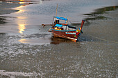  Before sunrise, a longtail boat moored at low tide at the harbor near Sivalai Beach, Koh Mook Island, Satun Province, Southern Thailand, Thailand, Asia 