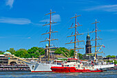  Port anniversary parade with many ships on the Elbe in front of the Landungsbrücken and the church of St. Michaelis, St. Pauli, Hamburg, Germany 