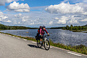  Cyclists at Lake Skálkká, Norrbotten County, Sweden 