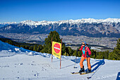  Woman on ski tour ascending the slope to the Glungezer, Inn Valley in the background, Glungezer, Tux Alps, Tyrol, Austria 