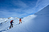  Two people on ski tour ascending to Rosskopf, Hochfügen, Tux Alps, Tyrol, Austria 