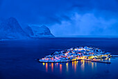  Illuminated village of Husoy on island in bad weather, Husoy, Senja, Troms, Norway 