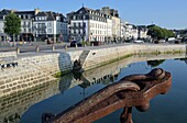  Rusted anchor at the entrance gate of the Ville Close in the old port of Concarneau, Brittany, Northern France 