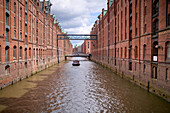  Canal and historic warehouses in Hamburg, Speicherstadt, Germany 