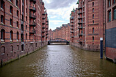  Canal and historic warehouses in Hamburg, Speicherstadt, Germany 