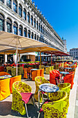  Colorful covers and seating in front of cafes on St. Mark’s Square, Venice,  