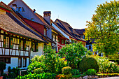 City Square with House and Tree in a Medieval Old Town in a Sunny Summer Day with Blue Sky in Regensberg, Zurich Canton, Switzerland.