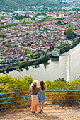 Two young women admiring the city of Cahors from the viewpoint at Mont Saint Cyr, Lot department, region of Midi-Pyrenees, Occitanie, southwest of France, Europe
