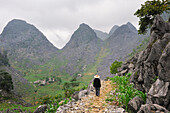 Man walking along a mountain path around Sa Phin, Ha Giang province, Northern Vietnam, Southeast Asia