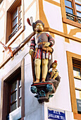  Wooden figure of William Tell on the corner house on Rue Guillaume Tell (Wilhelm Tell Gass) in Mulhouse, Alsace, France 