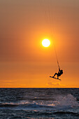  Kitesurfing at sunset on the west beach in Großenbrode, Baltic Sea, Ostholstein, Schleswig-Holstein, Germany 