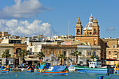 Luzzu fishing boats in the Harbour of Marsaxlokk, Malta, Mediterranean Sea,  Southern Europe