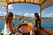 Boat trip on a "Dghajsa" in Grand Harbour from Three Cities to Valletta, Malta, Southern Europe