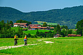  Man and woman mountain biking with the Leitzach Valley in the background, around the Wendelstein mountain, Mangfall Mountains, Bavarian Alps, Upper Bavaria, Bavaria, Germany 