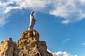  Statue of the Virgin Mary on a rock next to the pilgrimage chapel of Notre Dame de la Serra in Calvi, Balagne, Corsica, France 