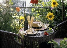 Small rattan table with two aperitifs, grissini & Parmesan