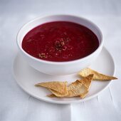 Beetroot soup in bowl, with taco chips